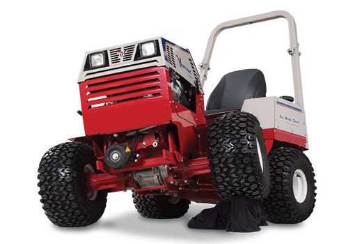 Red tractor with large tires, angled view showing undercarriage and pivoting frame for stability on uneven terrain