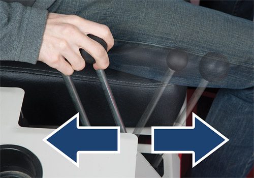A hand operates joystick controls, demonstrating intuitive driving mechanics of a Ventrac machine