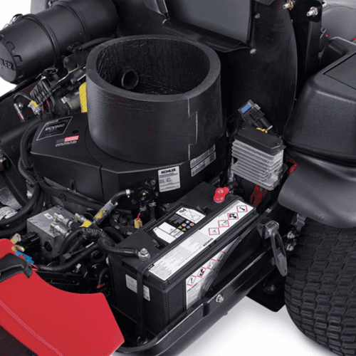 Close-up of the mower's engine compartment, showcasing the Kohler engine and battery components