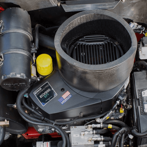 Close-up of the engine compartment showing the air filter and fuel components of the mower
