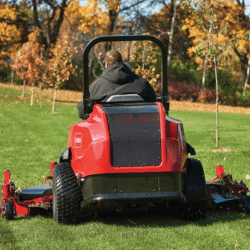 A Toro 7500-D mowing grass viewed from behind