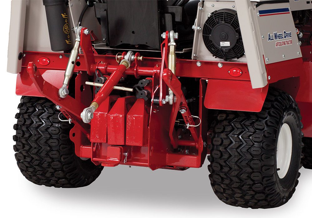 70.4100 Red three-point hitch attached to a Ventrac tractor, showcasing hydraulic couplers and control levers