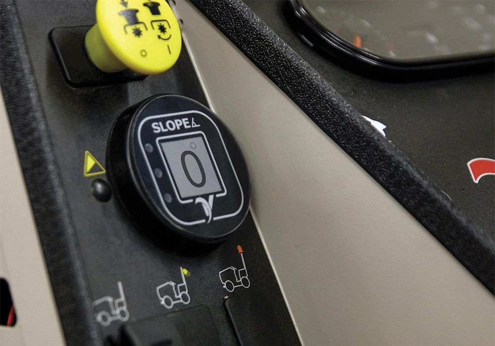 Close-up of control panel featuring slope adjustment dial and buttons in a multi-purpose tractor