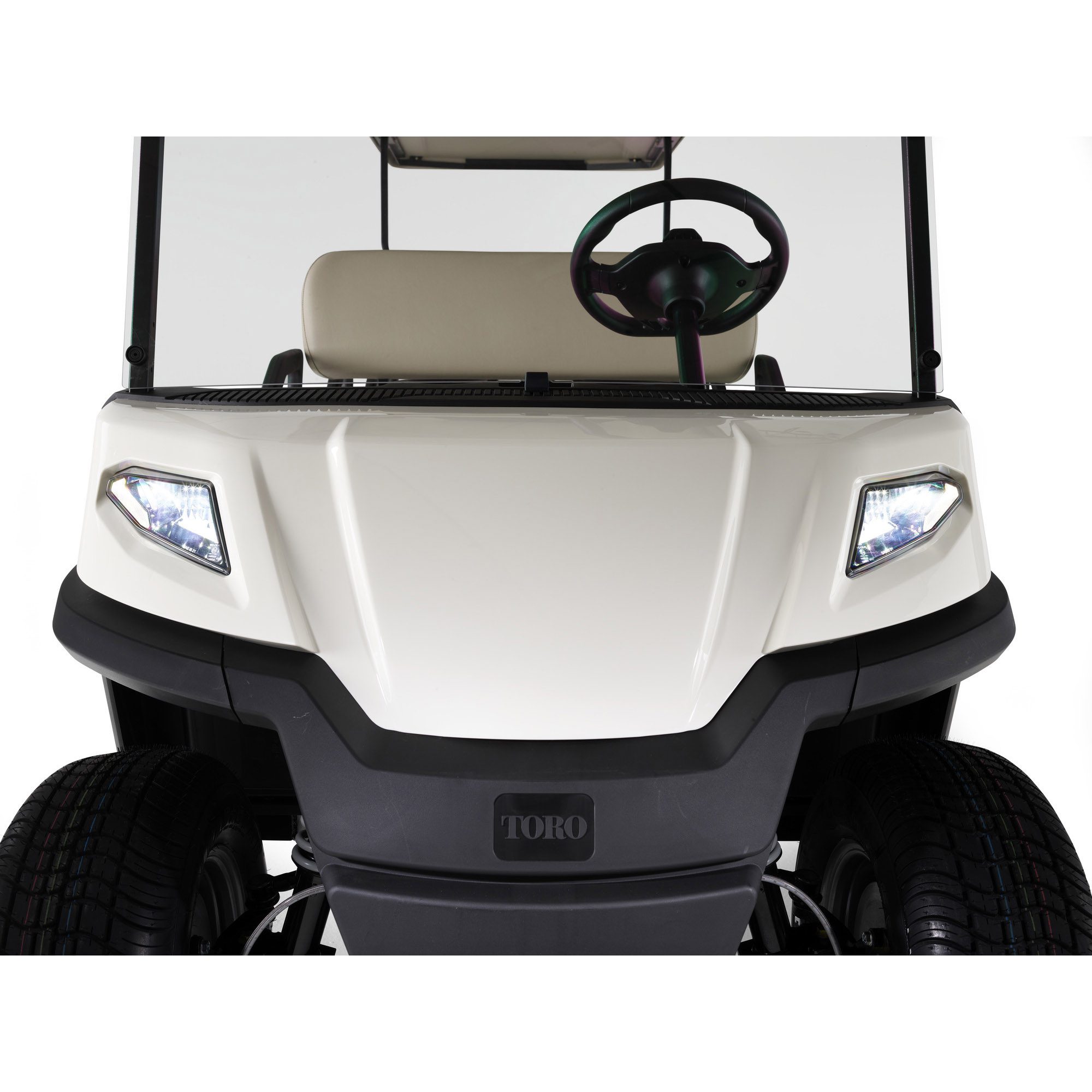 Toro Vista PTV front view with headlights on and beige seats studio Front view of the Toro Vista PTV with illuminated headlights, beige seating, and black steering wheel, captured in a studio setting