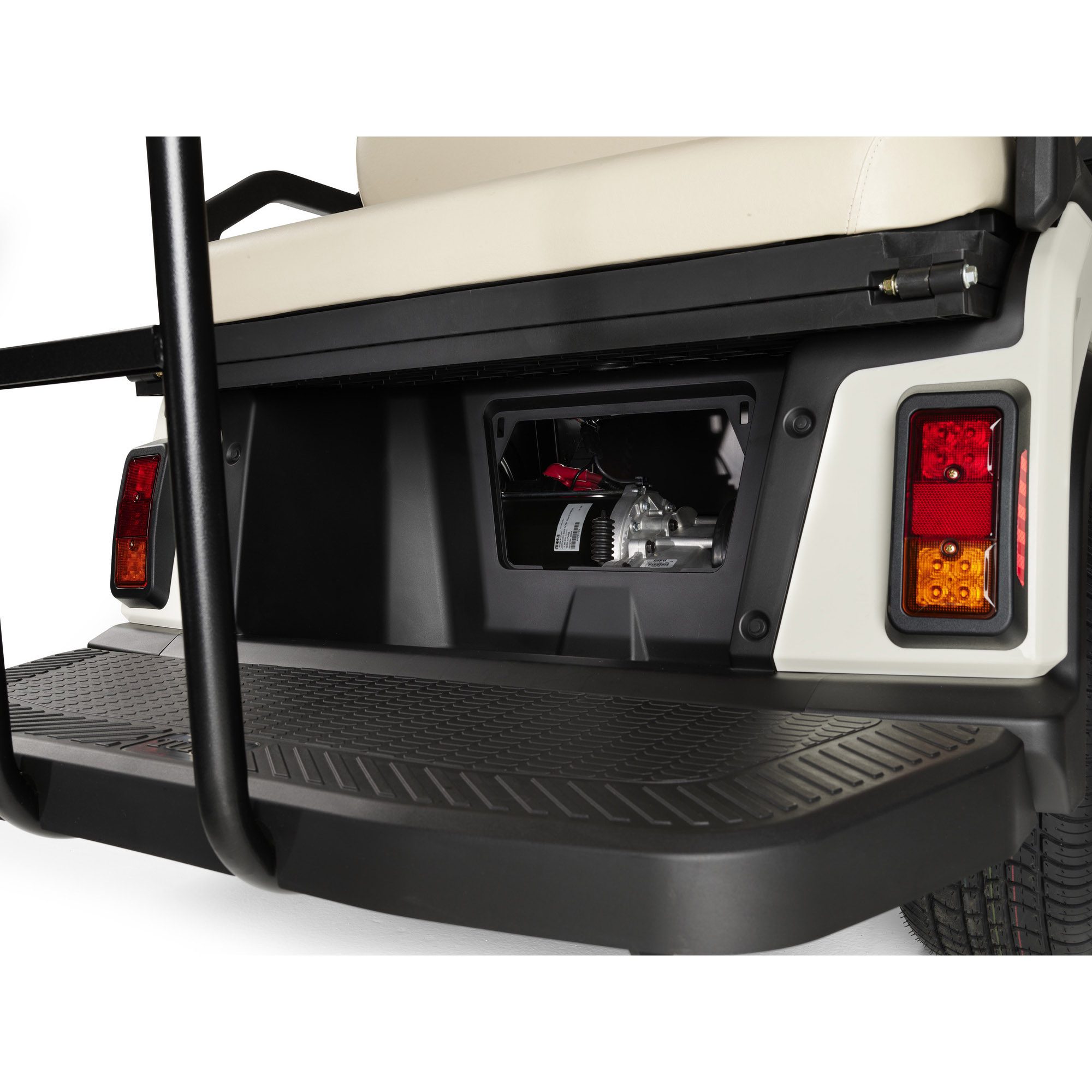 Toro Vista PTV rear compartment close-up with access panel and step Toro Vista PTV rear compartment showing an open access panel and beige rear seat, with a textured rear platform for passenger convenience