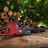 TORO Flex Force 60V Cordless Battery Chainsaw - beauty shot with logs in background