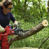 TORO Flex Force 60V Cordless Battery Chainsaw - lady cutting through log