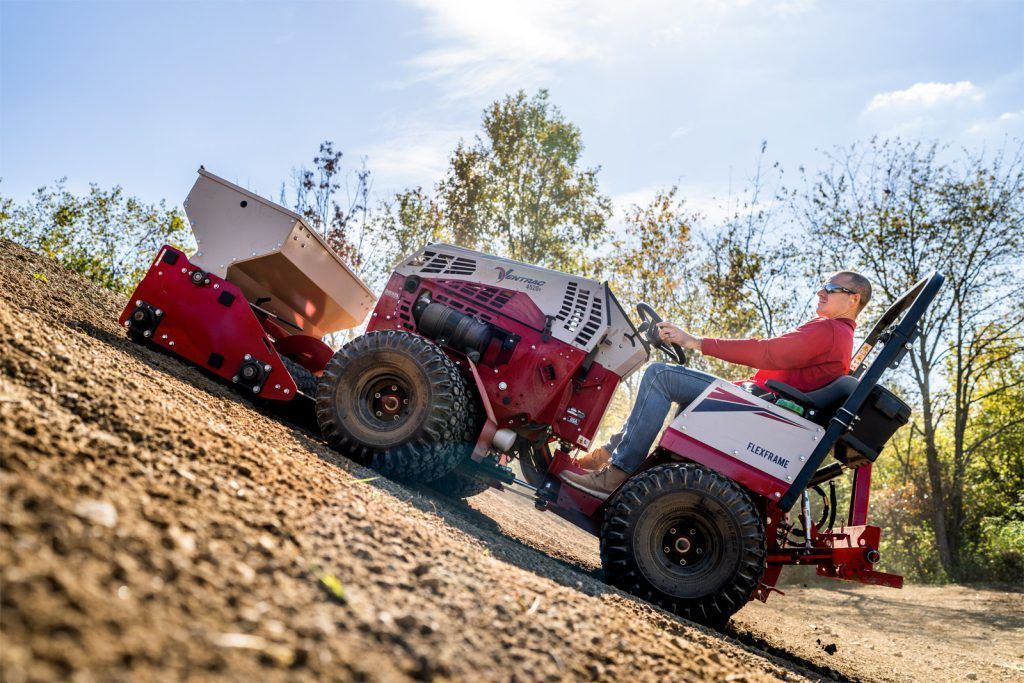 Ventrac 4520 and Seeder - Ventrac 4520 equipped with the EG520 spreading seed up a hill. Conquer slopes for seeding, mowing, and other tough jobs.