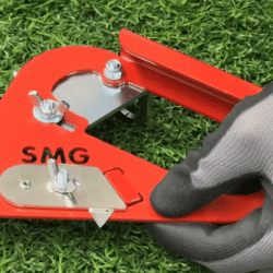 Close-up of a red turf edge trimmer with a gloved hand adjusting its components on artificial grass