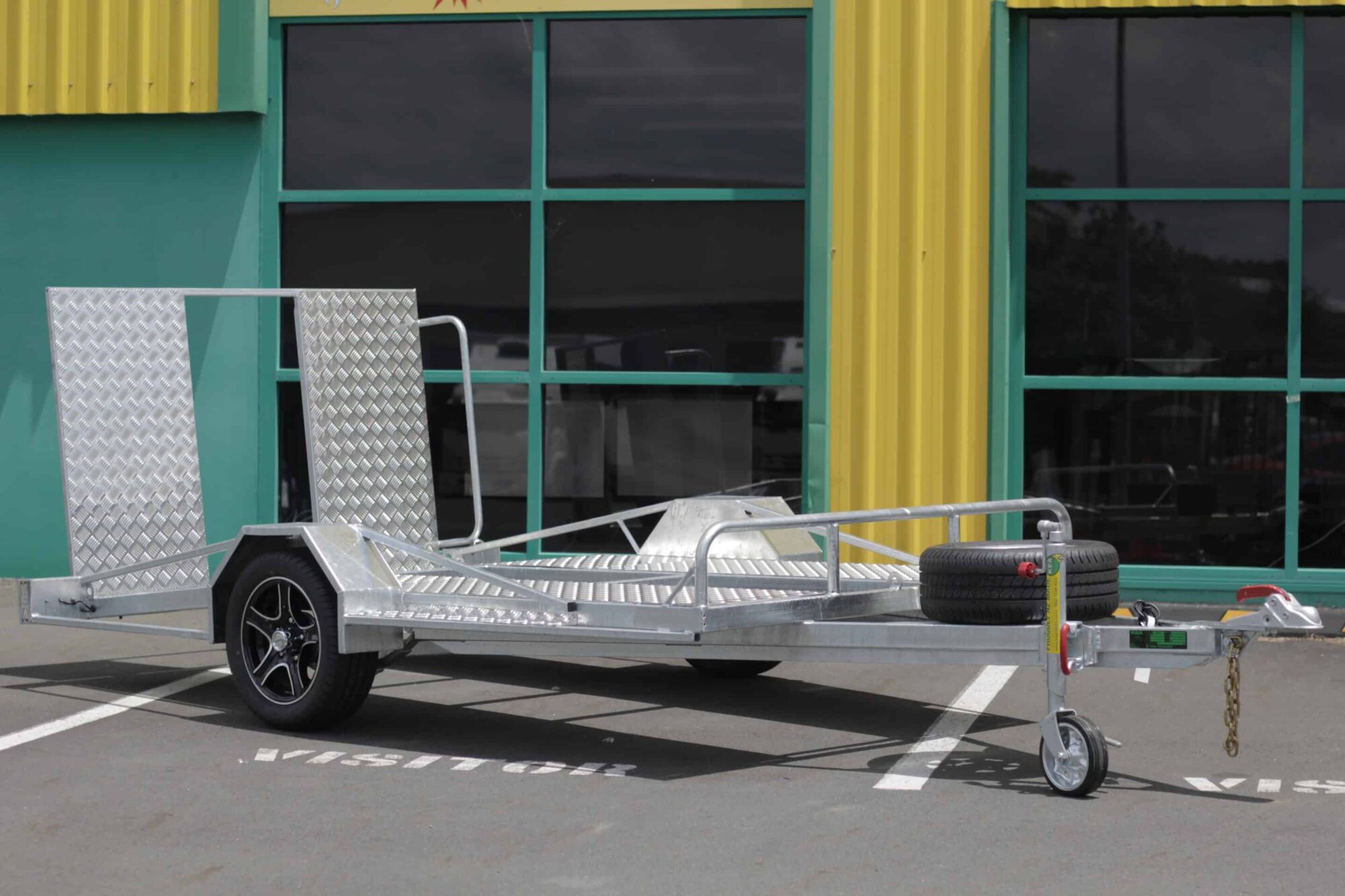 IMG_5827 A low-deck trailer with a light ramp, mag wheels, and a Duo-Fit coupling for golf cart transport