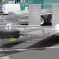 Low-deck trailer for golf carts with a light ramp, mag wheels, and Duo-Fit coupling
