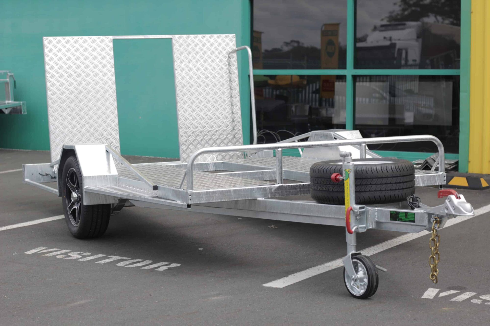 IMG_5850 Low-deck trailer for golf carts with a light ramp, mag wheels, and a spare tire