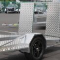 A low-deck trailer with a light ramp, mag wheels, and a Duo-Fit coupling for golf cart transport