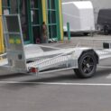 A low-deck trailer with mag wheels, light ramp, and Duo-Fit coupling for transporting golf carts