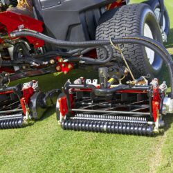 Close-up of Toro mower's cutting units showcasing precision adjustment and powerful engine components