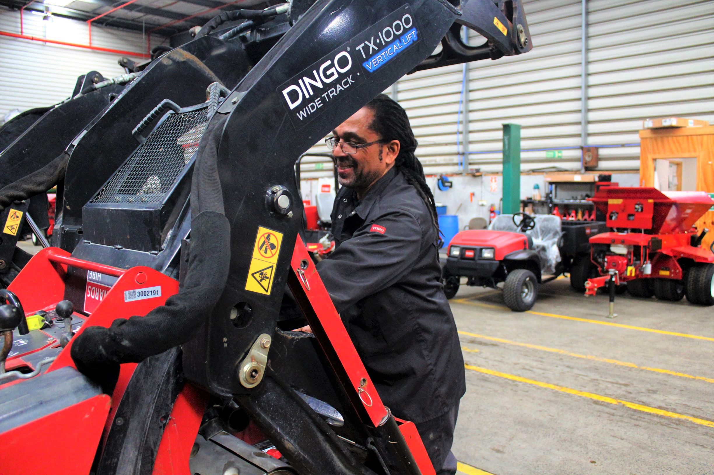 Service technician fixing a utility loader