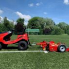 Tow-behind artificial turf cleaner