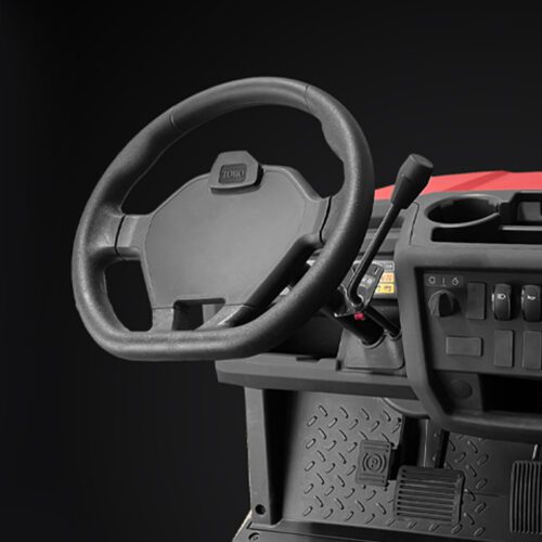 Close-up of the steering wheel and dashboard controls of a red utility vehicle