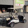 Silver 2015 Yamaha golf cart with lithium battery, parked outside a dealership, showing excellent condition