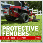 Close-up of Toro ride-on mower showing protective fenders and rear tires on grassy terrain