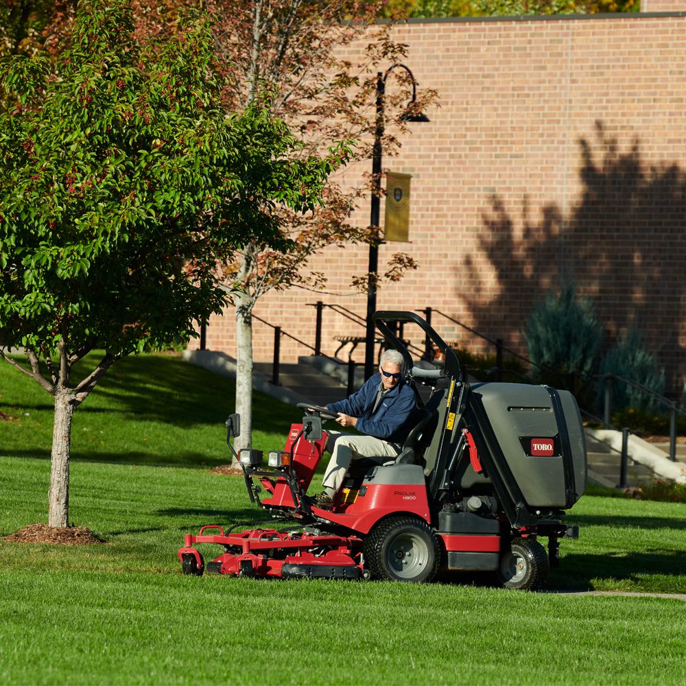 h800gallery3 A rider mower in action on a grassy area, featuring a red and black design with a driver