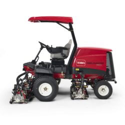 Side view of a red Toro ride-on mower showcasing cutting units and operator seat