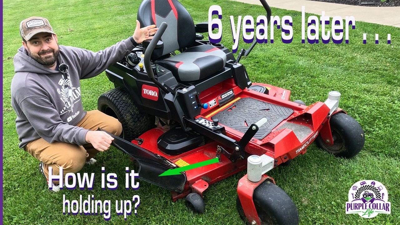 A man inspects a red Toro lawn mower on grass, highlighting its condition after six years