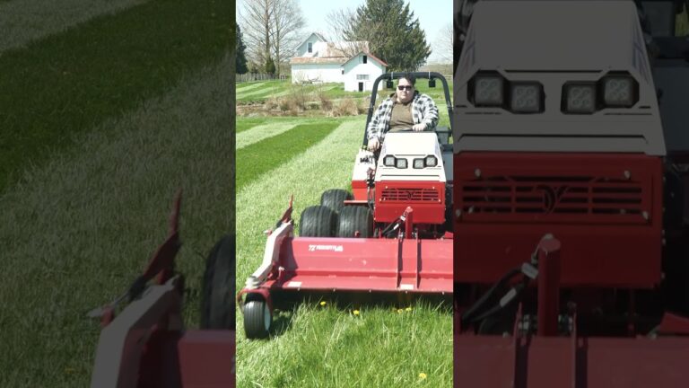 A person operates a Ventrac mower on a lush, overgrown lawn with trees and a house in the background